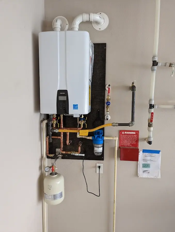 Professional plumber installing copper piping in a Inman home